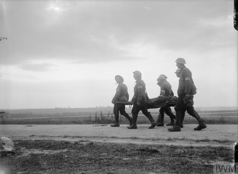 British combat medics carrying a wounded soldier on a stretcher at the Battle of the Somme