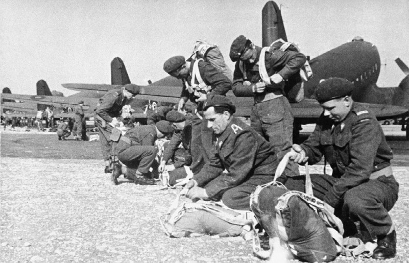 Polish paratroopers checking their equipment in front of a line of C-47 Aircraft prior to heading for Arnhem.