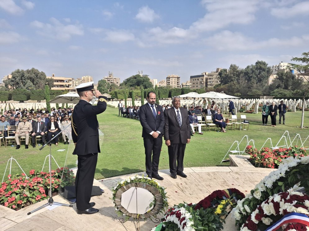 Figures pay their respects to the fallen at Heliopolis War Cemetery, Egypt