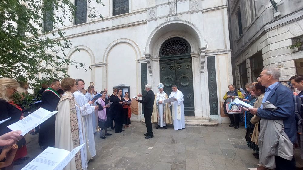 Guests outside St George's Anglican Church singing hymns.