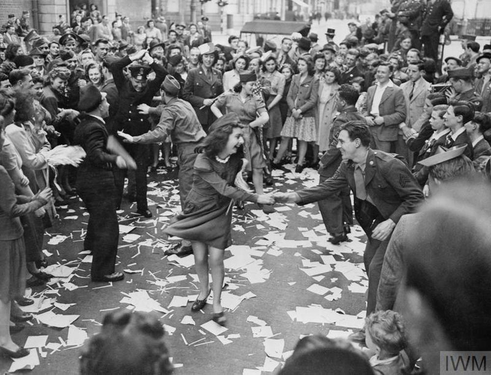British girls dancing in the streets with American GIs during VE Day celebrations in London, May 1945.