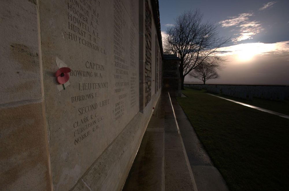 Name panel of the Caterpilllar Valley Memorial with a small poppy tribute taped to the stone.