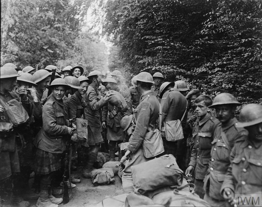 Men of the 6th Battalion, Black Watch (51st Division) about to encamp in woods near St. Imoges after the capture of the Bois de l'Aulnay, 25 July 1918. An underage soldier is clearly visible on the left of the group of soldiers.