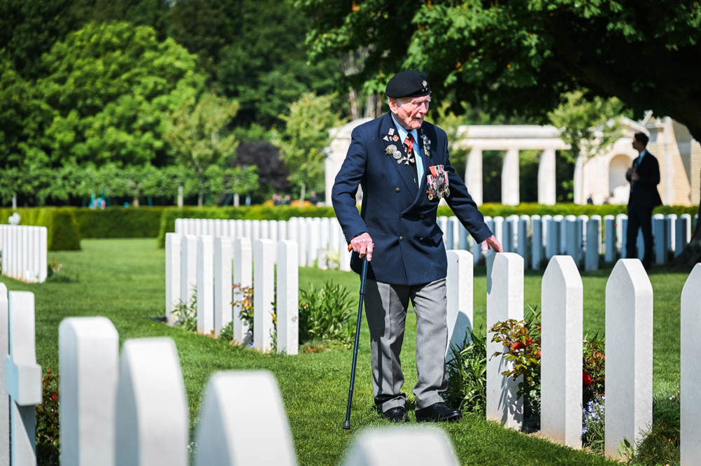 WW2 veteran inspects war graves at Bayeux War Cemetery