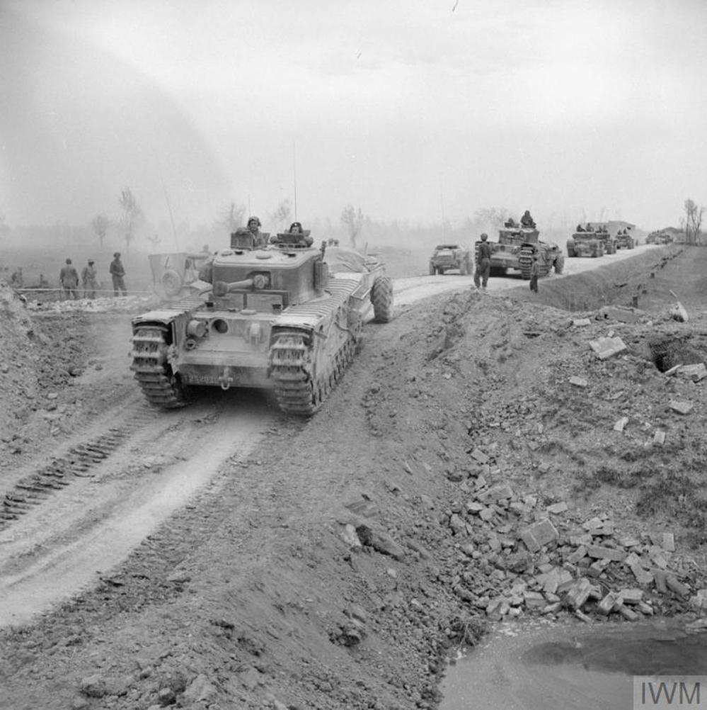 Crocodile flamethrower tanks leading an armoured column up a dirt road near Imola, Italy, April 1945.