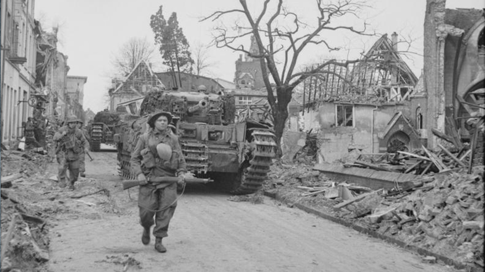 A British Soldier leading a column of WW2 era Churchill tank through the ruine streets of Cleve during the invasion of Germany.