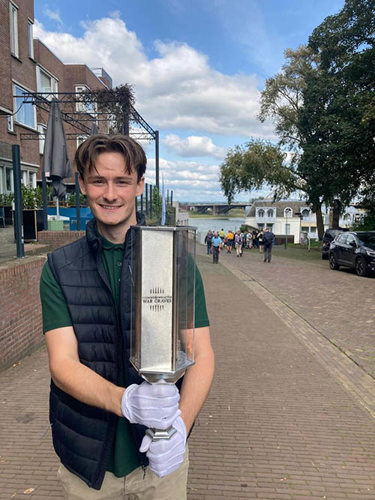 Harvey holding up the CWGC Torch for Peace on an Arnhem street.