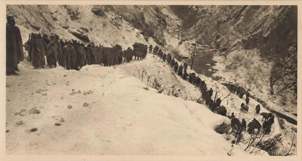 A column of Serbian troops travering a snow-covered mountain pass as the army retreats.