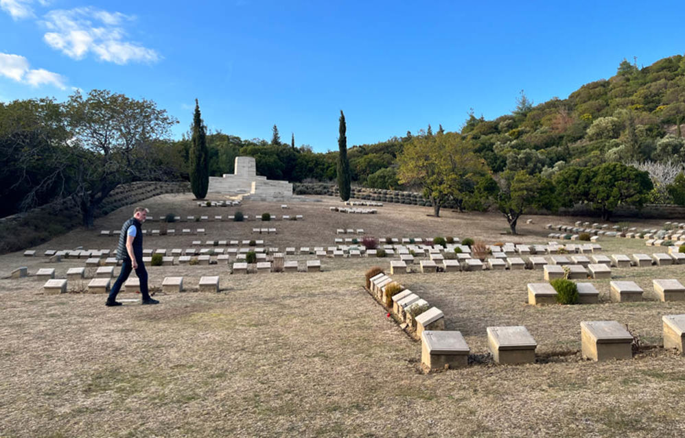 Man walks past the low grave markers at Shrapnel Valley war cemetery in Gallipoli.