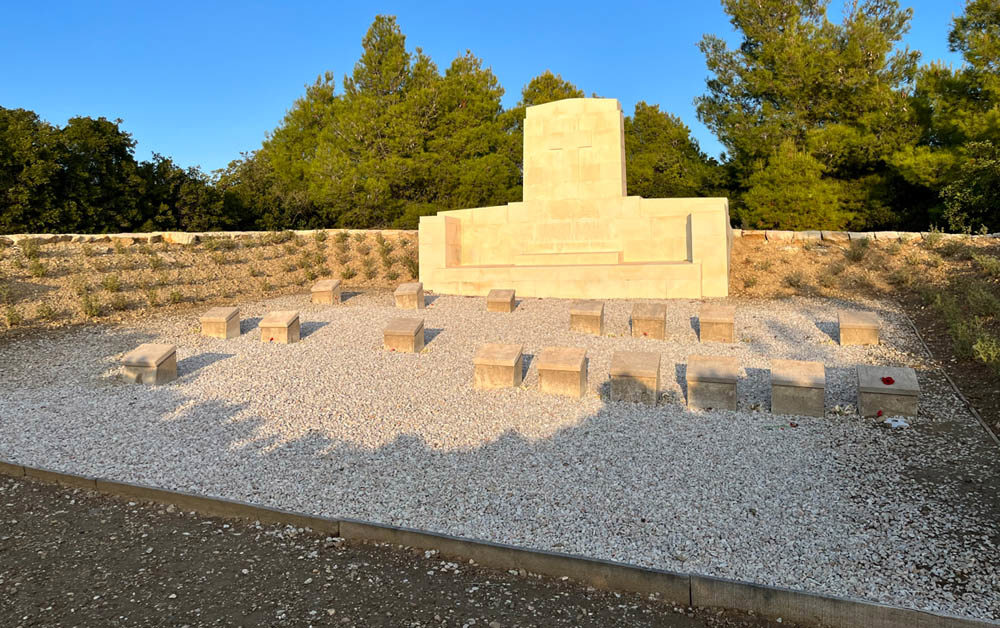 Stone of Remembrance and low grave markers in a small Gallipoli war cemetery.