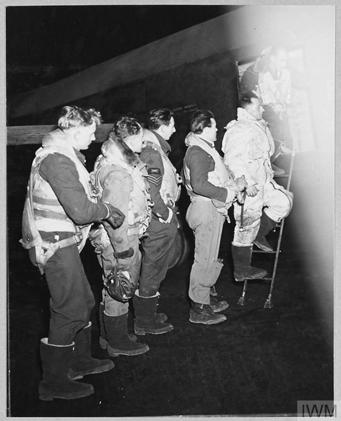 The crew of a Lancaster Bomber boarding the aircraft.