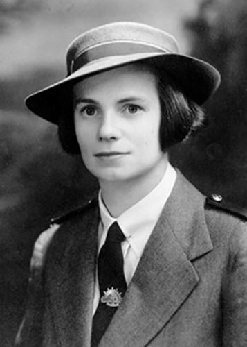 Sister Elaine Balfour-Ogilvy in a peaked hat set at a jaunty angle. She has bobbed dark hair and large expressive brown eyes. She is wearing a formal nursing uniform.