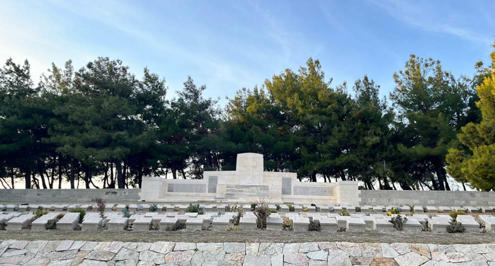 Stone of Remembrance and rows of war grave markers at Twelve Tree Copse cemetery