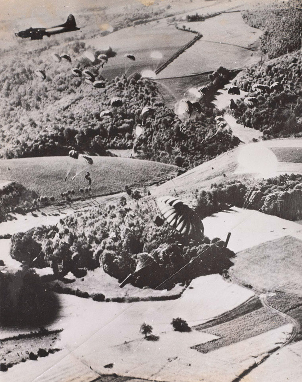 A transport plane drops supplies into Normandy circa 1944.